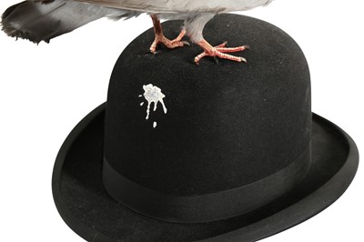 Lot 180 - A TAXIDERMY PIGEON PERCHED ON A BOWLER HAT