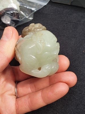 Lot 365 - A CHINESE PALE CELADON JADE 'LION DOGS' GROUP.