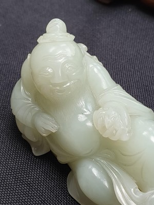 Lot 131 - A CHINESE PALE CELADON JADE FIGURE OF AN IMMORTAL.