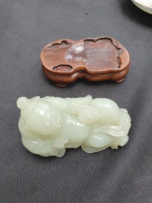 Lot 131 - A CHINESE PALE CELADON JADE FIGURE OF AN IMMORTAL.