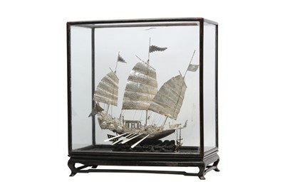 Lot 690 - A CHINESE SILVER MODEL OF A WAR JUNK.
