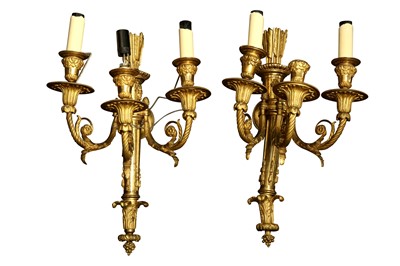 Lot 443 - A PAIR OF THREE LIGHT GILT BRONZE WALL LIGHTS, IN THE LOUIS XVI STYLE, LATE 19TH CENTURY