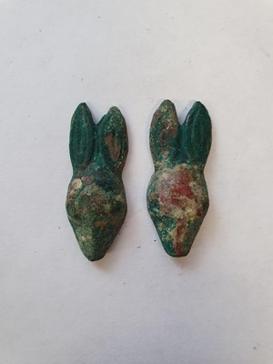 Lot 44 - A PAIR OF CHINESE BRONZE RABBIT HEAD ORNAMENTS.