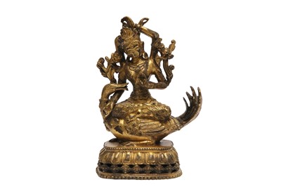 Lot 1099 - A SINO-TIBETAN GILT-BRONZE FIGURE OF A FOUR-ARMED TARA.