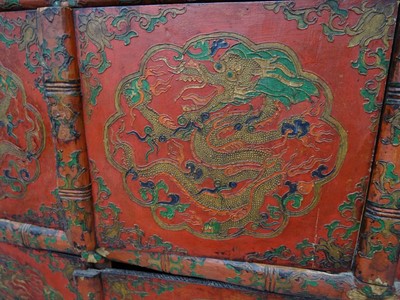 Lot 108 - A TIBETAN RED LACQUERED SIDE CABINET
