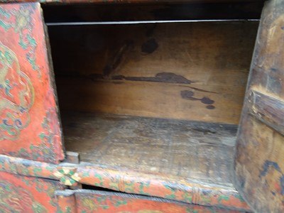 Lot 108 - A TIBETAN RED LACQUERED SIDE CABINET