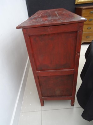 Lot 108 - A TIBETAN RED LACQUERED SIDE CABINET