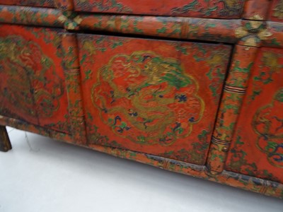 Lot 108 - A TIBETAN RED LACQUERED SIDE CABINET