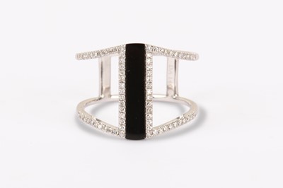 Lot 314 - AN ONYX AND DIAMOND DRESS RING