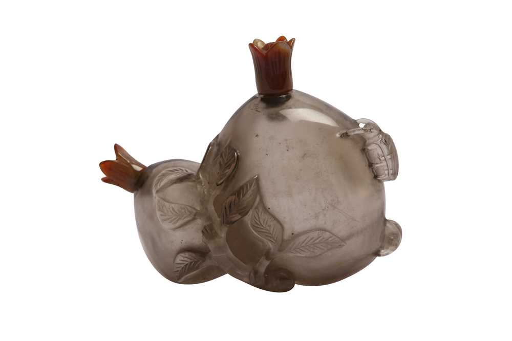 Lot 102 - A CHINESE SMOKY CRYSTAL 'DOUBLE POMEGRANATE' SNUFF BOTTLE.