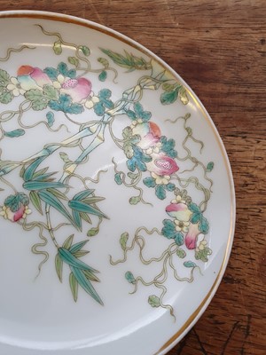Lot 426 - A PAIR OF CHINESE FAMILLE ROSE 'BITTER MELLON' SAUCERS.