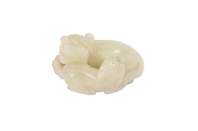 Lot 668 - A CHINESE WHITE JADE 'LION DOG' GROUP.