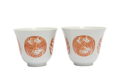 Lot 847 - A PAIR OF CHINESE IRON-RED 'DRAGON AND PHOENIX' CUPS.