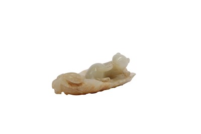 Lot 653 - A CHINESE PALE CELADON JADE 'CAT' CARVING.