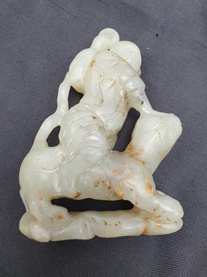 Lot 130 - A CHINESE PALE CELADON JADE FIGURE OF AN IMMORTAL.