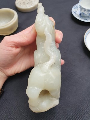 Lot 130 - A CHINESE PALE CELADON JADE FIGURE OF AN IMMORTAL.