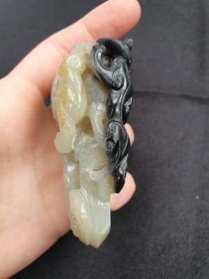 Lot 578 - A CHINESE PALE CELADON JADE ARCHAISTIC 'AXE' PENDANT.