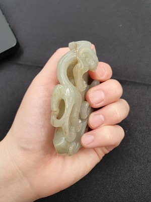 Lot 578 - A CHINESE PALE CELADON JADE ARCHAISTIC 'AXE' PENDANT.