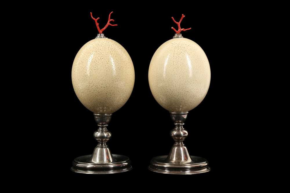 Lot 25 - A PAIR OF MID-CENTURY OSTRICH EGGS MOUNTED WITH MEDITERRANEAN CORAL