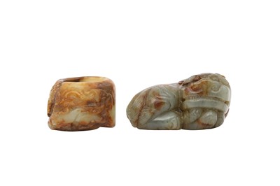 Lot 669 - A CHINESE GREY JADE CARVING OF A LION DOG AND A YELLOW JADE ARCHER’S RING.