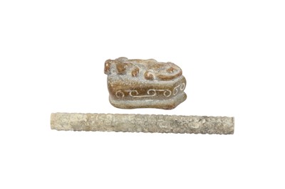 Lot 670 - A CHINESE PALE CELADON JADE CYLINDRICAL BEAD TOGETHER WITH A JADE ‘CHILONG’ TOGGLE.
