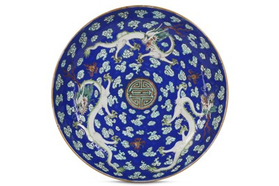 Lot 283 - A CHINESE FAMILLE ROSE BLUE-GROUND 'DRAGON' DISH.