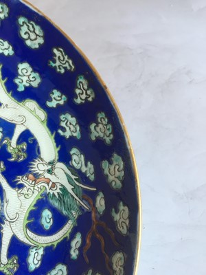 Lot 283 - A CHINESE FAMILLE ROSE BLUE-GROUND 'DRAGON' DISH.