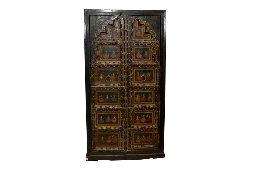 Lot 140 - A PAIR OF INDIAN WINDOW SHUTTERS INCORPORATED INTO A LATER RAJASTHANI CUPBOARD