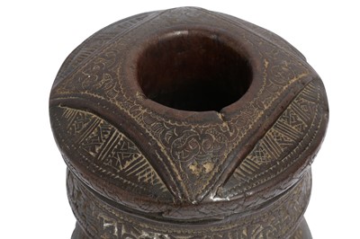 Lot 294 - A CARVED WOOD COFFEE GROUNDER WITH PSEUDO-CALLIGRAPHIC BAND