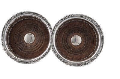 Lot 495 - A pair of George IV sterling silver wine coasters, Sheffield 1828 by John and Thomas Settle