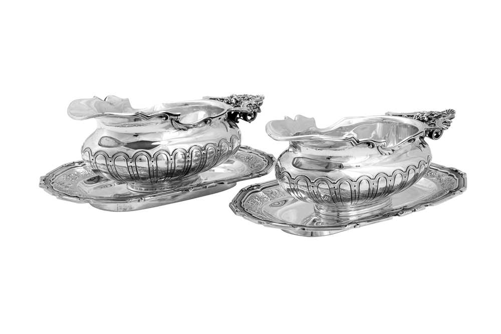 Lot 138 - A pair of early 20th century French 950 standard silver sauceboats on stands, Paris circa 1910 by Cardeilhac