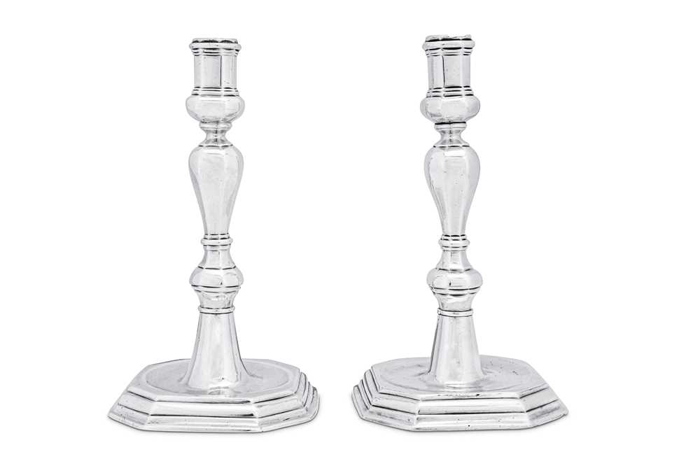 Lot 128 - A rare pair of Louis XV early 18th century French provincial silver candlesticks, Saintes 1725-27 by Benjamin Avrard (master 1711, still living 1742)