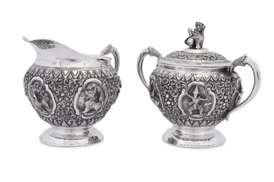 Lot 208 - An early 20th century Burmese unmarked silver milk jug and covered twin handled sugar bowl, Thayetmyo circa 1900