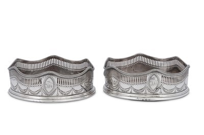 Lot 643 - A pair of George III sterling silver wine coasters, London 1788 apparently no maker’s mark