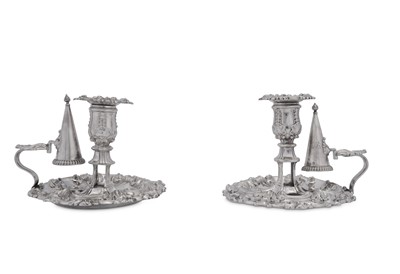 Lot 494 - A pair of George III and George IV sterling silver chambersticks, Sheffield 1814/27 by James Kirkby, Waterhouse & Co and Waterhouse, Hodson & Co respectively
