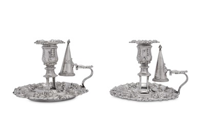 Lot 494 - A pair of George III and George IV sterling silver chambersticks, Sheffield 1814/27 by James Kirkby, Waterhouse & Co and Waterhouse, Hodson & Co respectively
