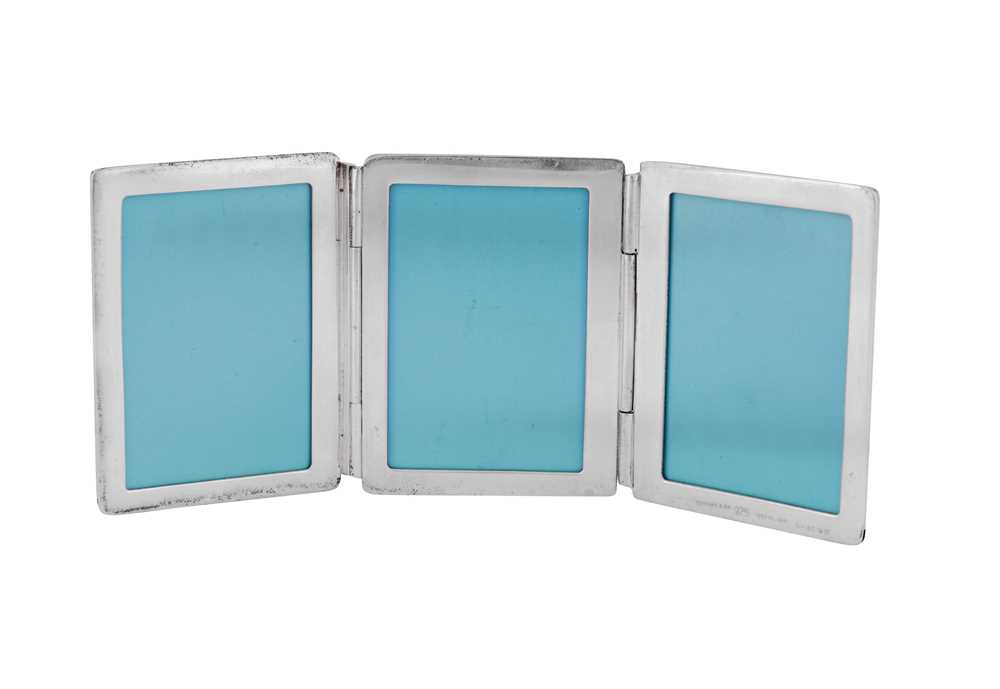 Lot 42 - A late 20th century small American sterling silver triple photograph frame, New York by Tiffany and Co, import marks for London 1998