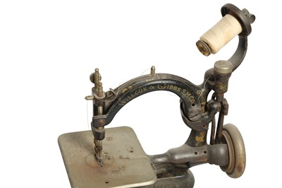 Lot 238 - HABERDASHERY: A WILCOX AND GIBBS TABLE MOUNTED MINIATURE SEWING MACHINE