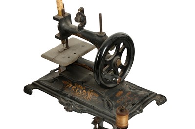 Lot 238 - HABERDASHERY: A WILCOX AND GIBBS TABLE MOUNTED MINIATURE SEWING MACHINE