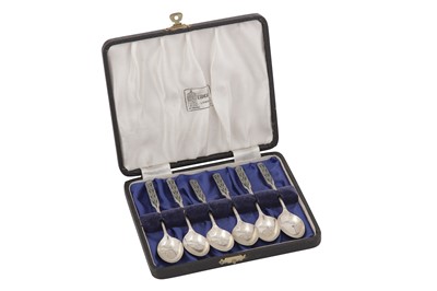 Lot 498 - A cased set of George V ‘Arts and Crafts’ sterling silver and enamel teaspoons, Birmingham 1925 by Liberty and Co