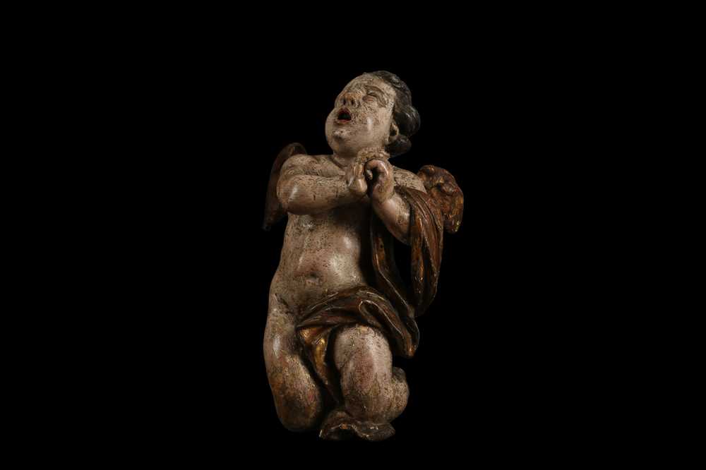 Lot 15 - AN EARLY 17TH CENTURY SOUTH GERMAN POLYCHROME DECORATED AND CARVED WOOD FIGURE OF A CHERUB