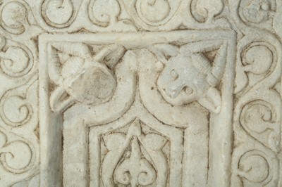 Lot 263 - A CARVED WHITE MARBLE RELIEF WITH HORNED DEVILS