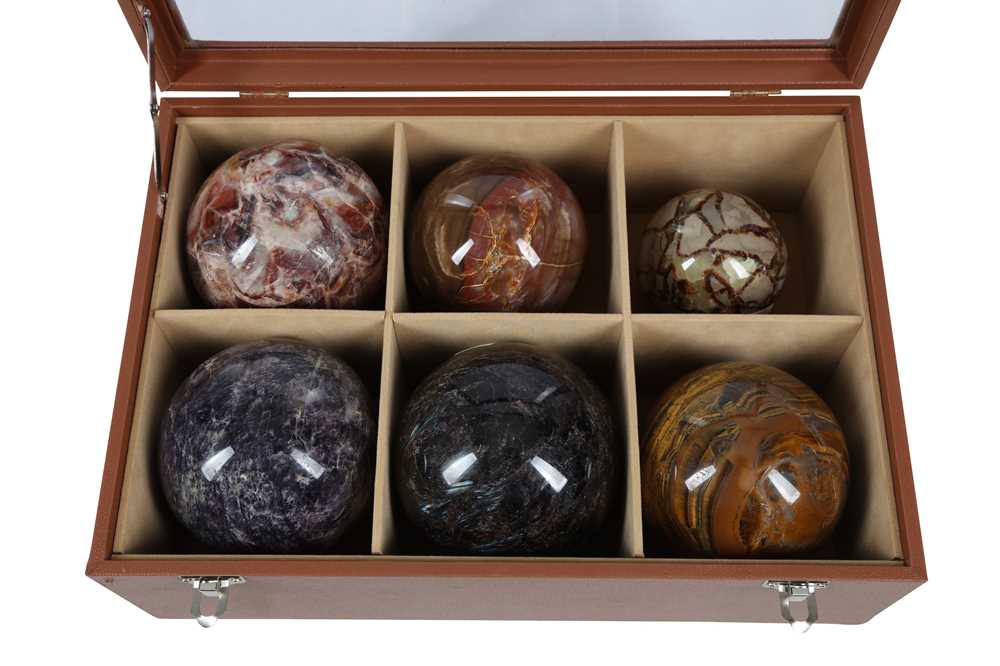 Lot 274 - A CASED SET OF SIX SPECIMEN HARDSTONE SPHERES, 20TH CENTURY