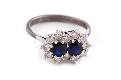 Lot 728 - A SAPPHIRE DOUBLET AND DIAMOND CLUSTER RING, 1975