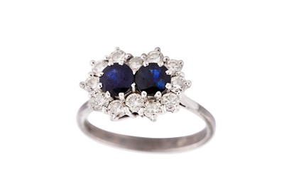 Lot 728 - A SAPPHIRE DOUBLET AND DIAMOND CLUSTER RING, 1975