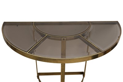 Lot 227 - A PAIR OF SMOKED GLASS AND GILT-METAL DEMI LUNE CONSOLE TABLES