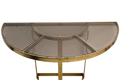 Lot 227 - A PAIR OF SMOKED GLASS AND GILT-METAL DEMI LUNE CONSOLE TABLES