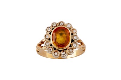 Lot 99 - A yellow sapphire and diamond cluster ring