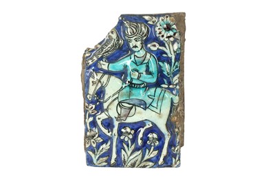 Lot 1083 - A FRAGMENTARY MOULDED QAJAR POTTERY TILE