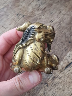 Lot 649 - A CHINESE GILT-BRONZE 'QILIN' PAPERWEIGHT.